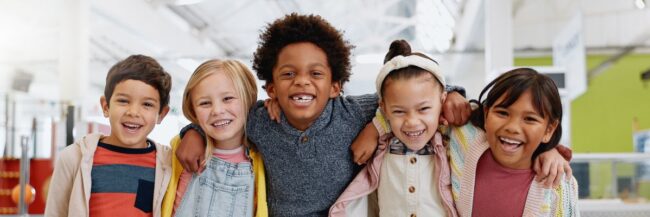 Children with arms around each other and smiling