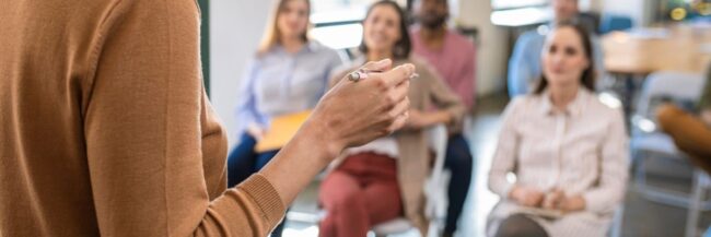 Woman lecturing in front of group
