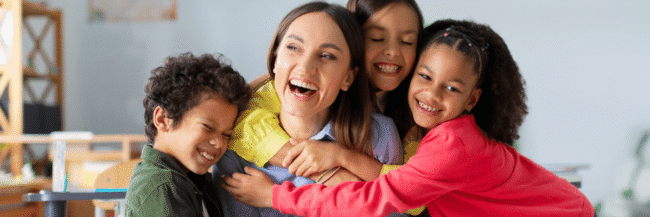 Students hugging their teacher