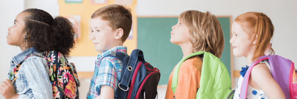 Four students standing in line in class