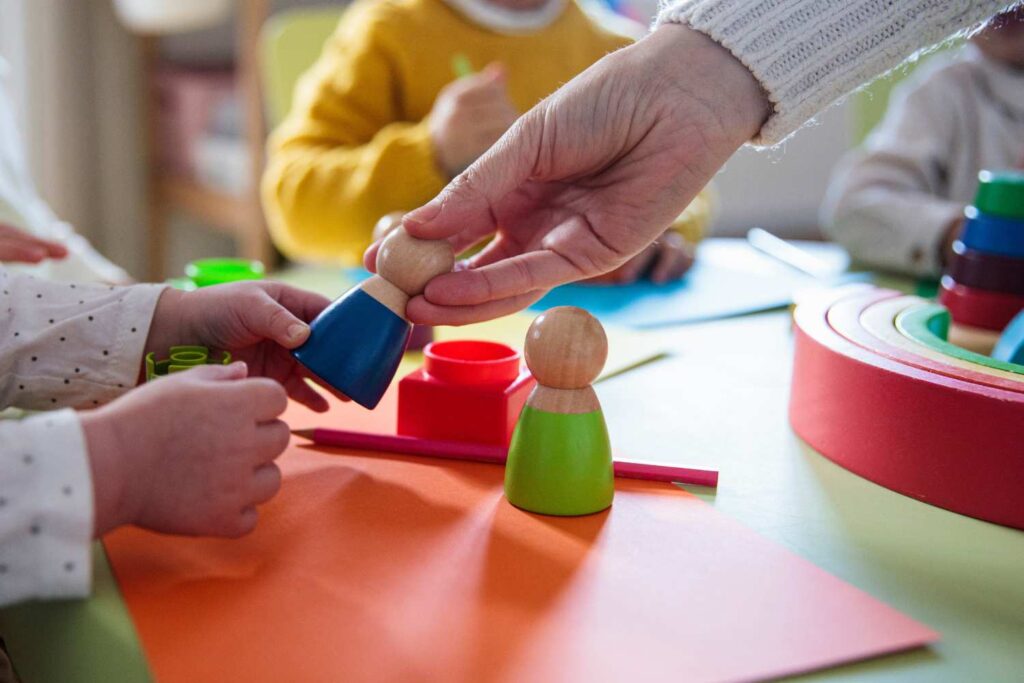 Teacher handing a child a toy