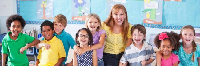Teacher and elementary class smiling and laughing