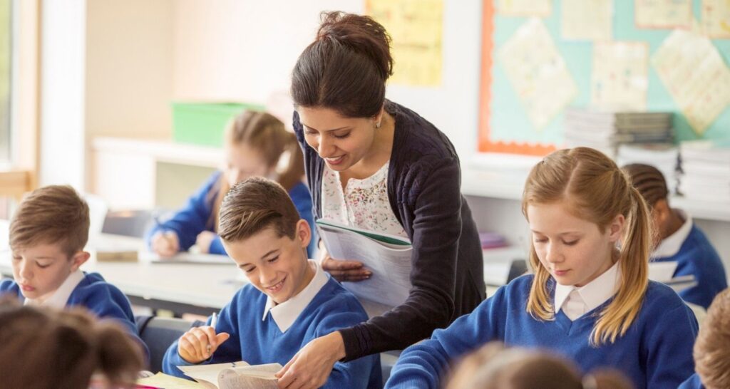 Substitute Helper Substitute teacher helping a student