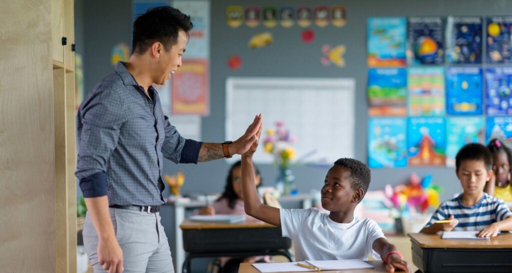 Teacher high fiving student