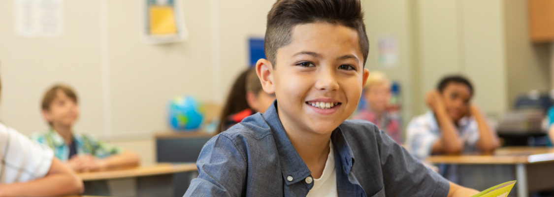 Hispanic Student Boy Using Studies Weekly Social Studies Curriculum