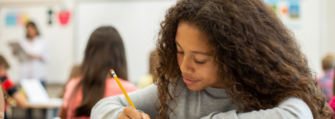 Student writing on studies weekly publication Studies Weekly Student Working